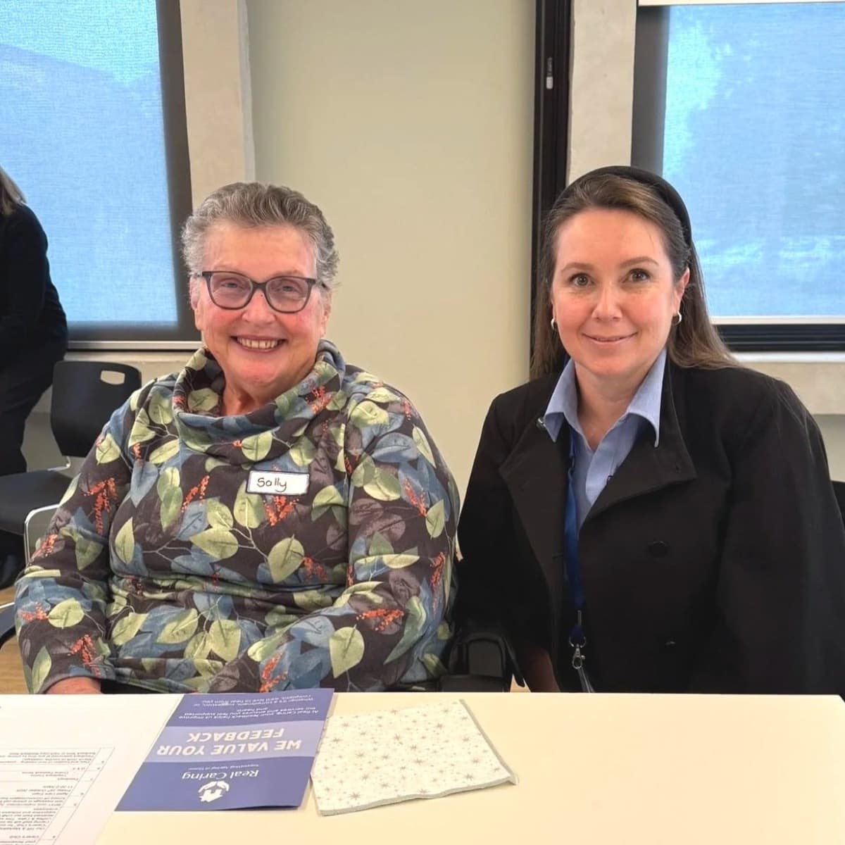 A Real Caring team member sitting with a client