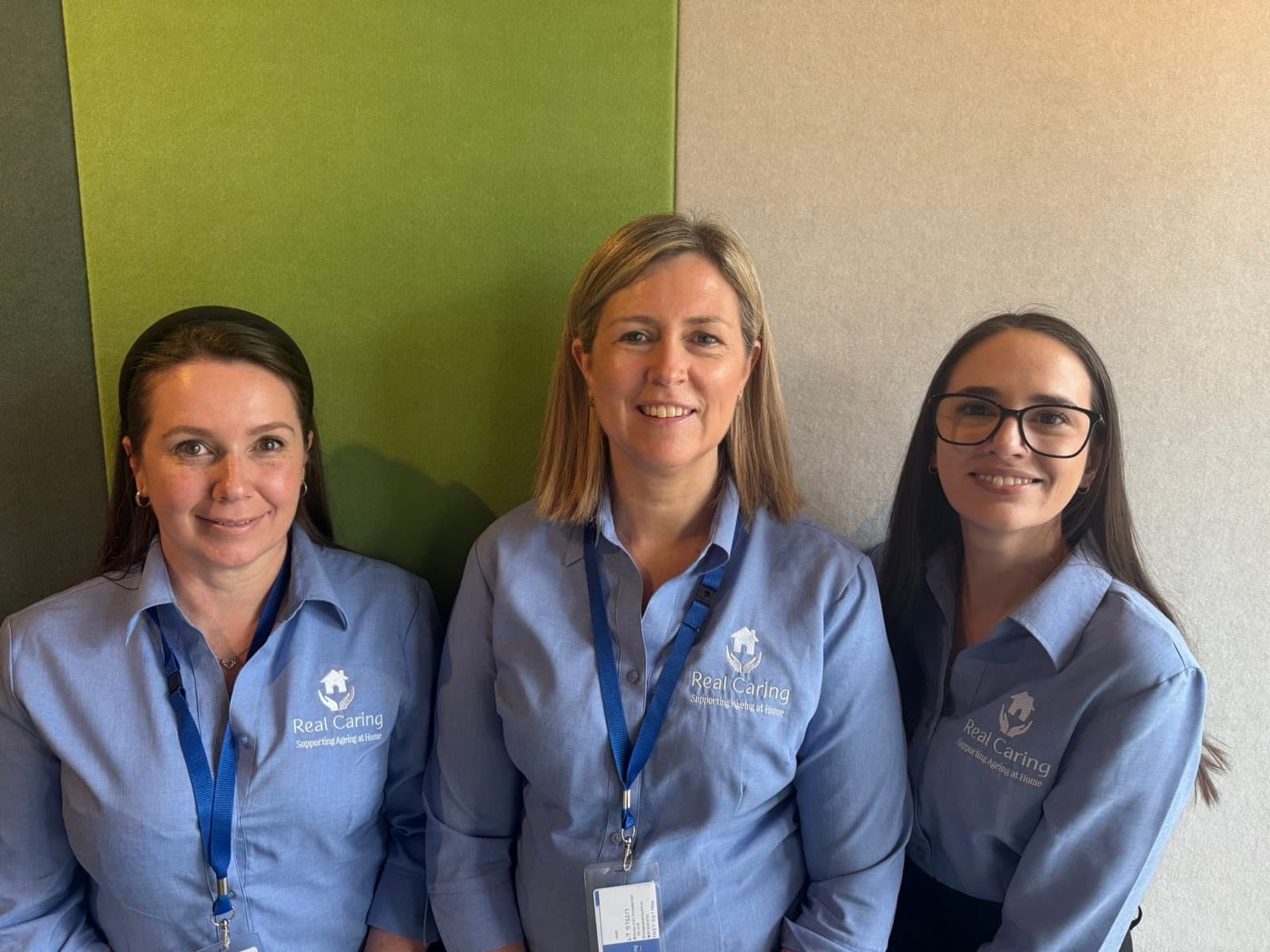 Three Real Caring team members in uniform at the Geelong office